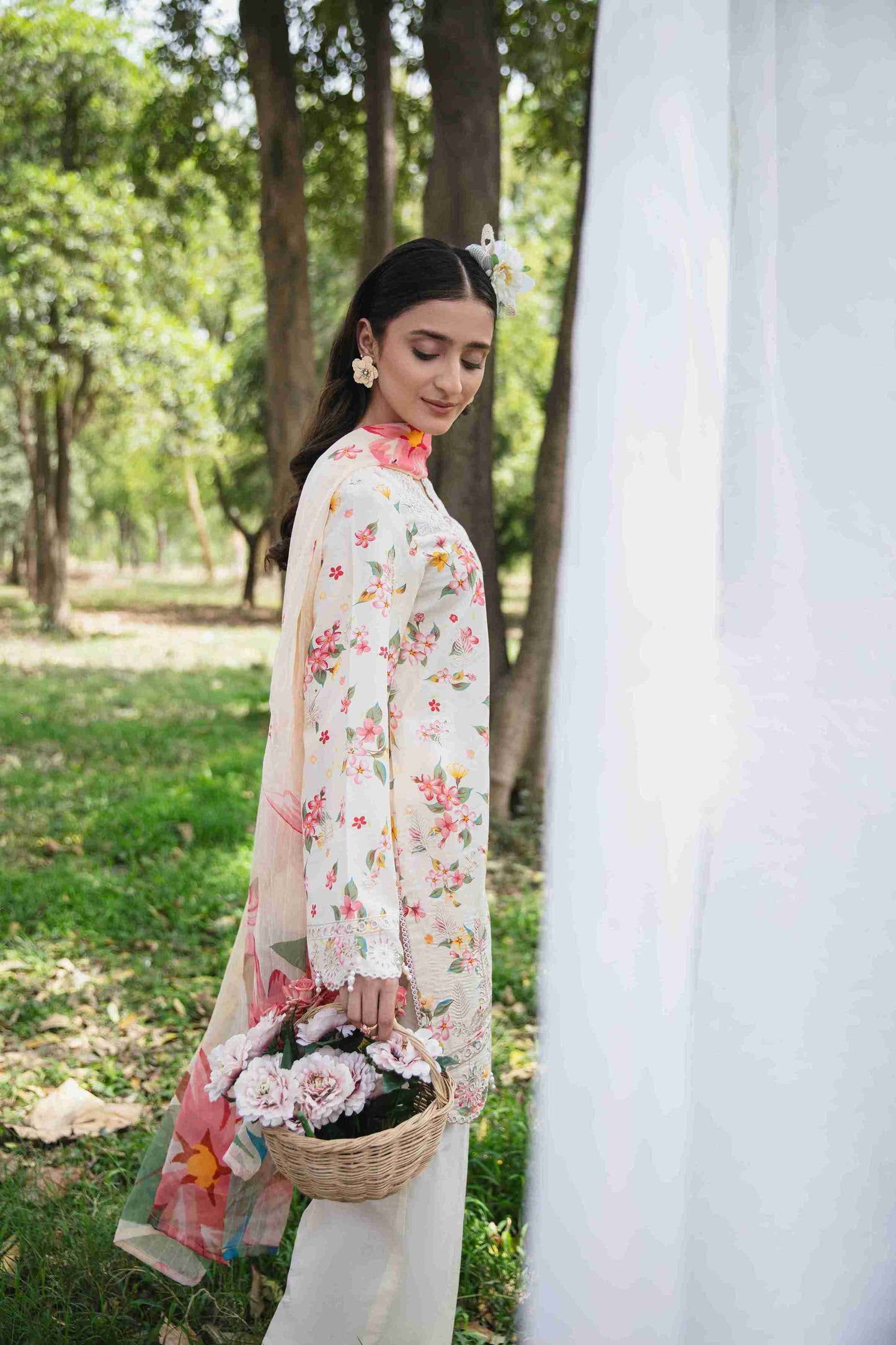 Embroidered lawn outfit styled with chiffon dupatta and cotton trouser.