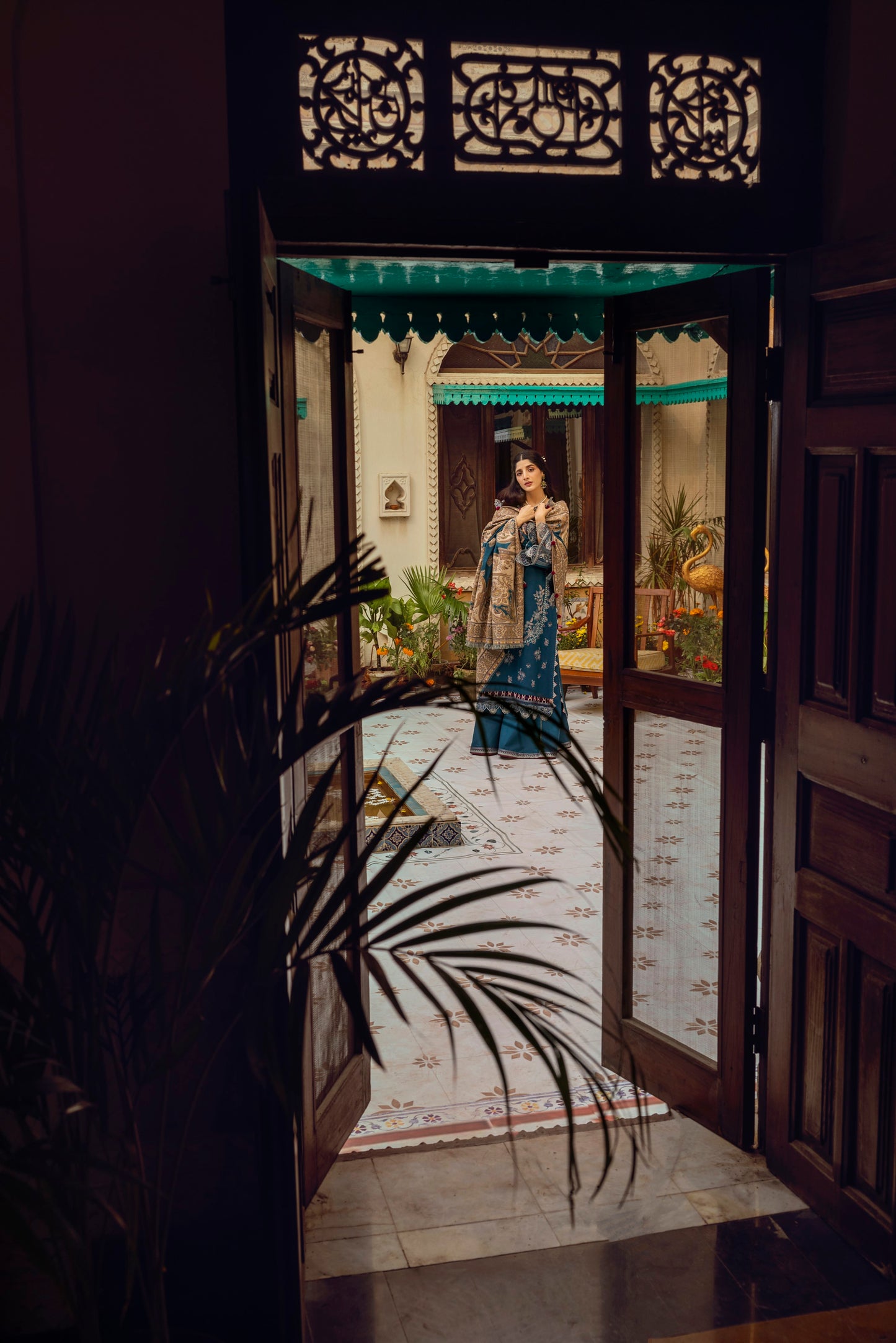 A cozy winter suit featuring Marina woollen fabric, organza neckwork, embroidered borders, and a traditional woven shawl.