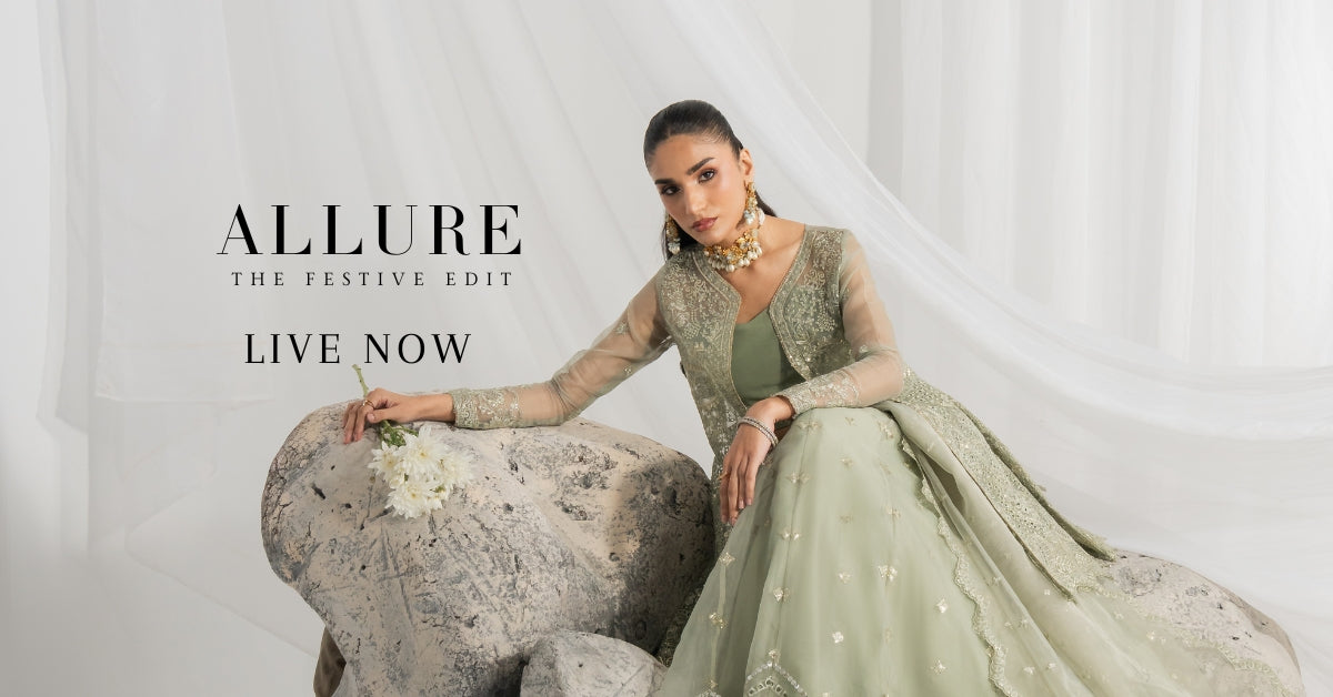 A women wearing intricate embroidered 3PC festive suit featuing long frog design with organza sleeves 