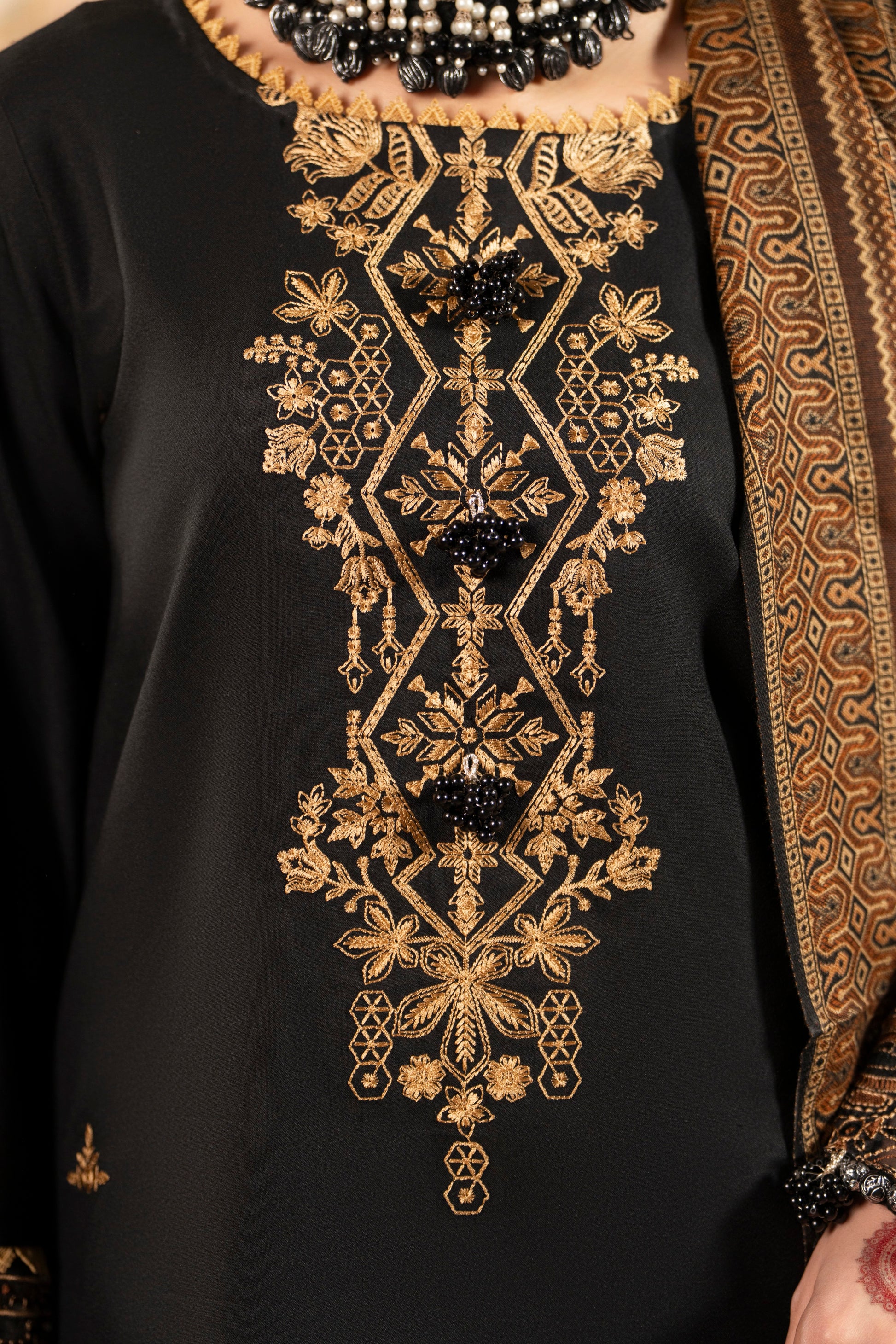 Traditional embroidered Dhanak shirt with warm wool shawl and plain trousers for winter styling.