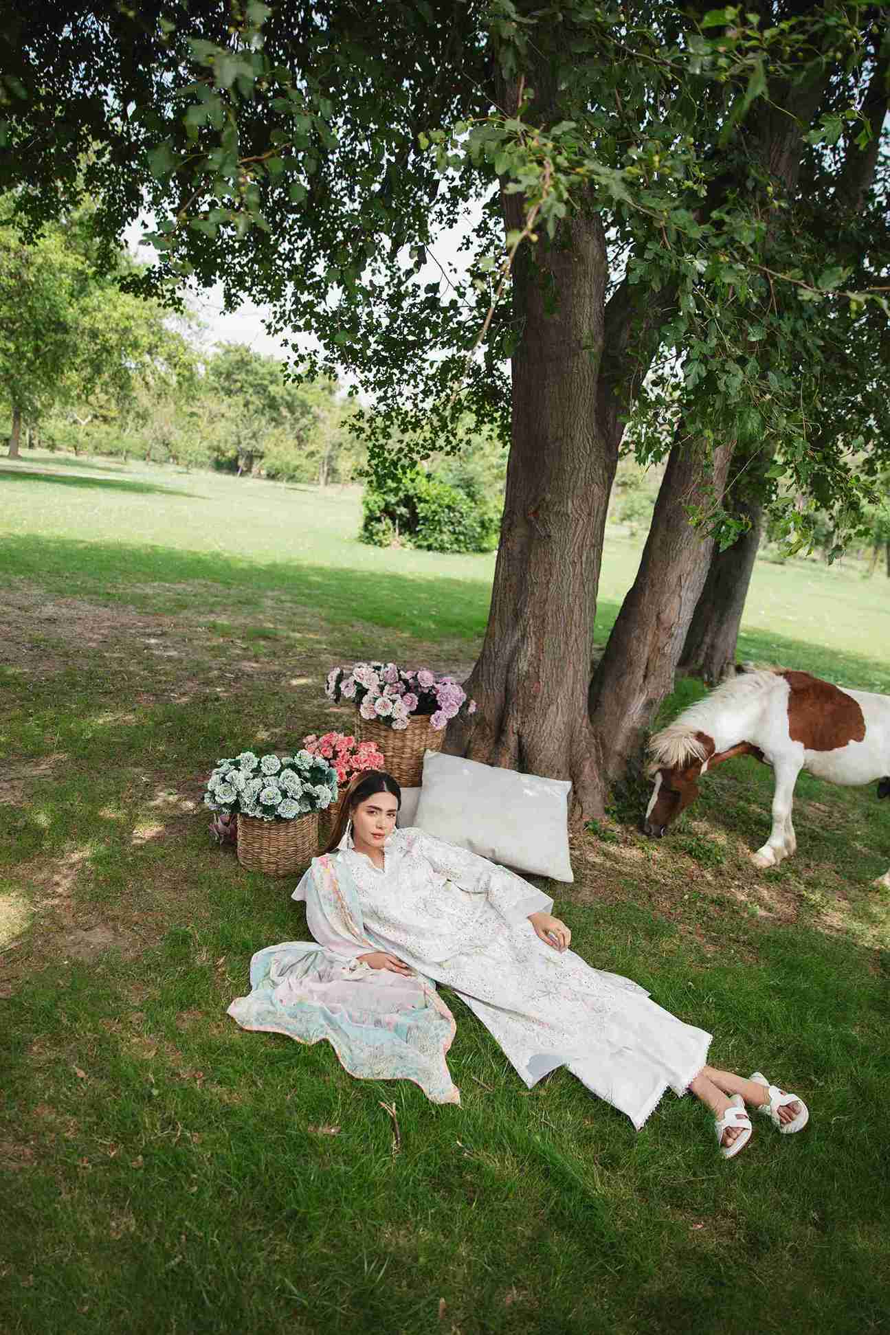 Embroidered lawn shirt styled with chiffon dupatta and plain trouser.