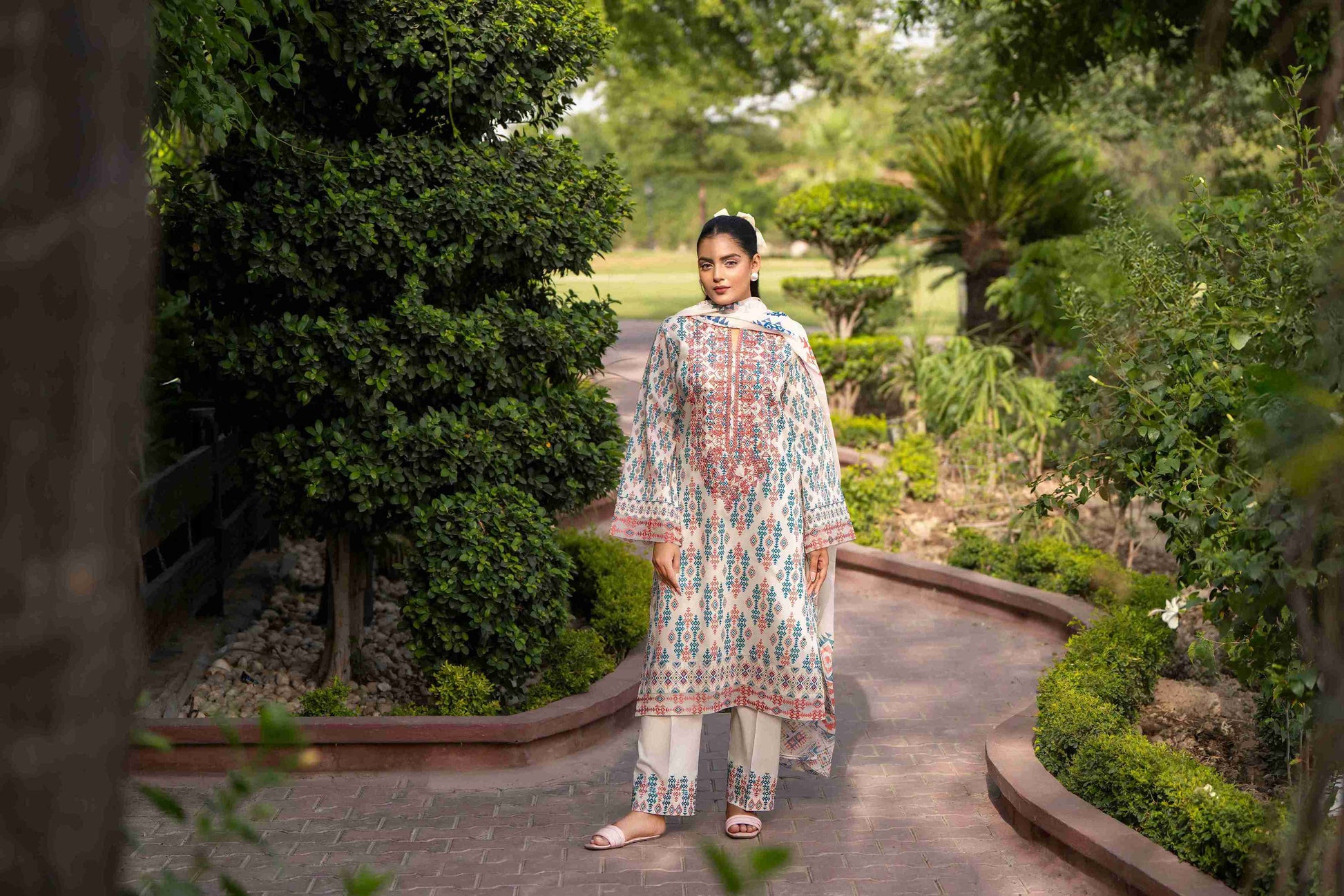 Richly colored kurta featuring embroidered neckline, airy chiffon dupatta, and breathable cotton trouser