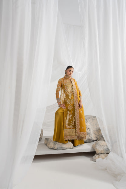 Embroidered organza suit for women featuring beautifully detailed front panels, an embroidered back, decorated sleeves and matching borders, with an embroidered organza dupatta, plain raw silk inner, and pants