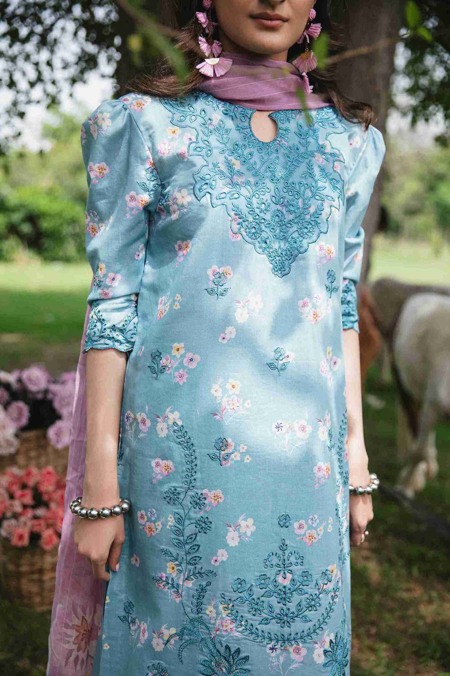 Embroidered lawn dress styled with chiffon dupatta and cotton trouser.