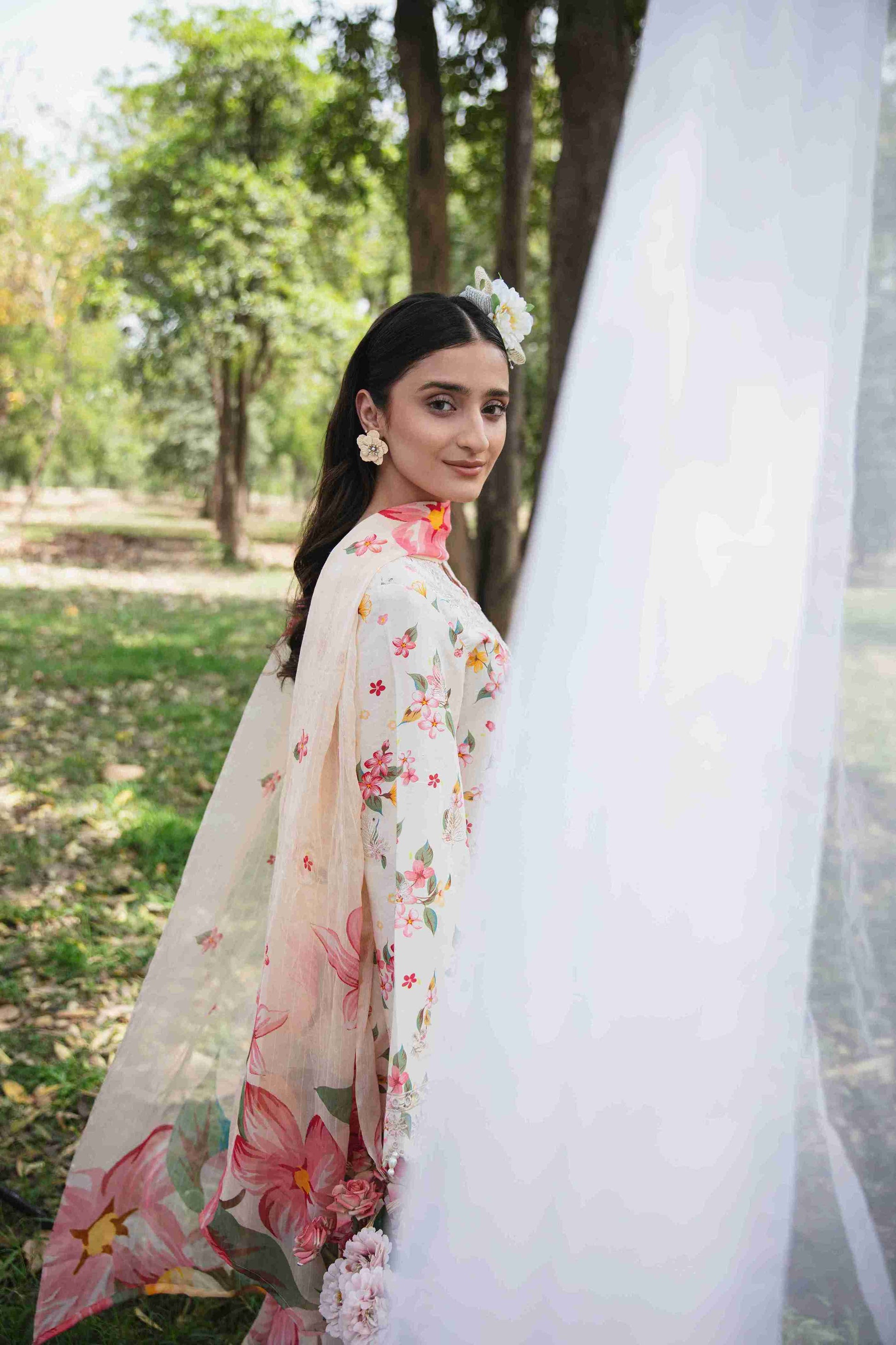 Embroidered lawn suit styled with chiffon dupatta and plain dyed trouser.