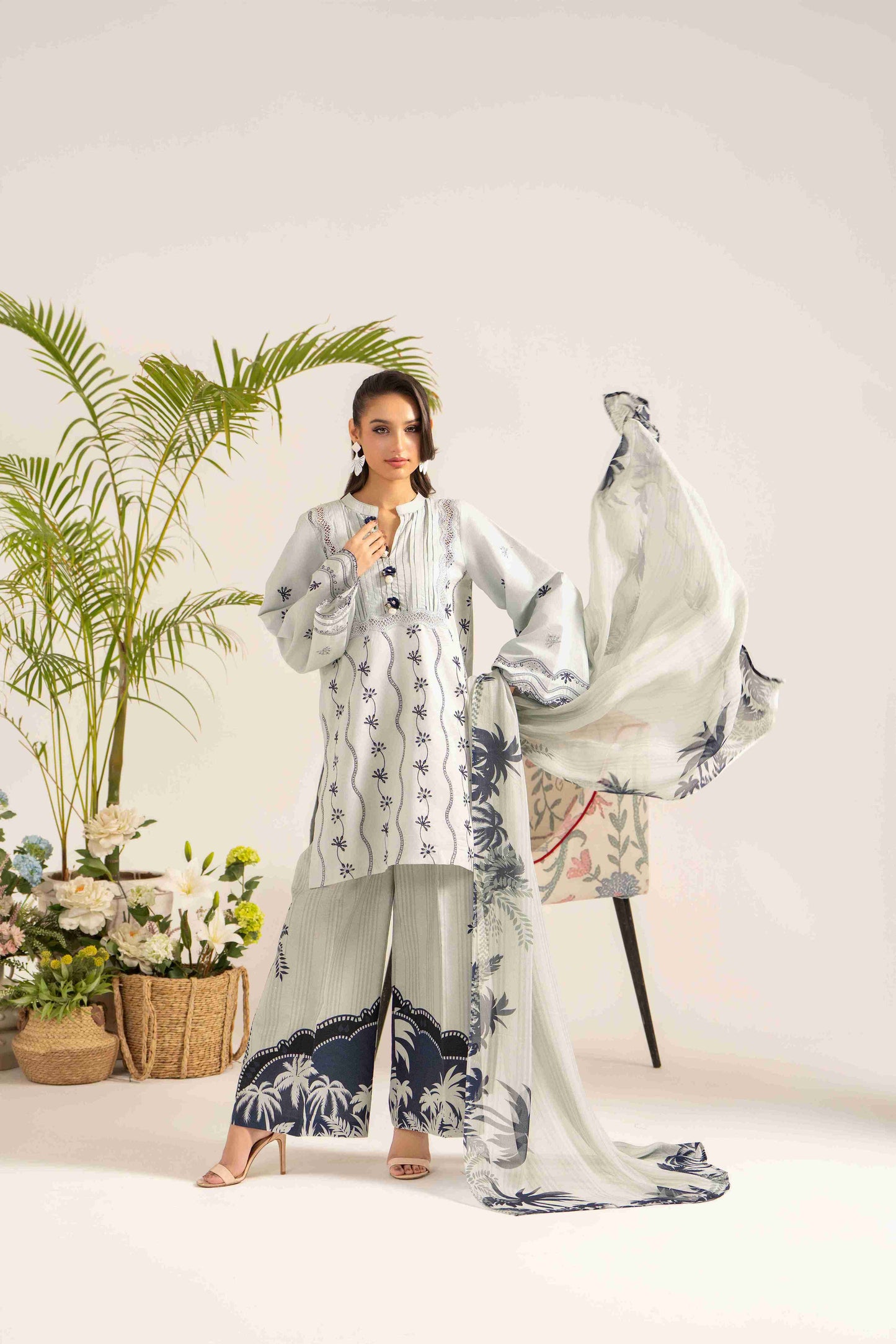  Festive embroidered lawn shirt styled with chiffon dupatta and plain cotton trouser.