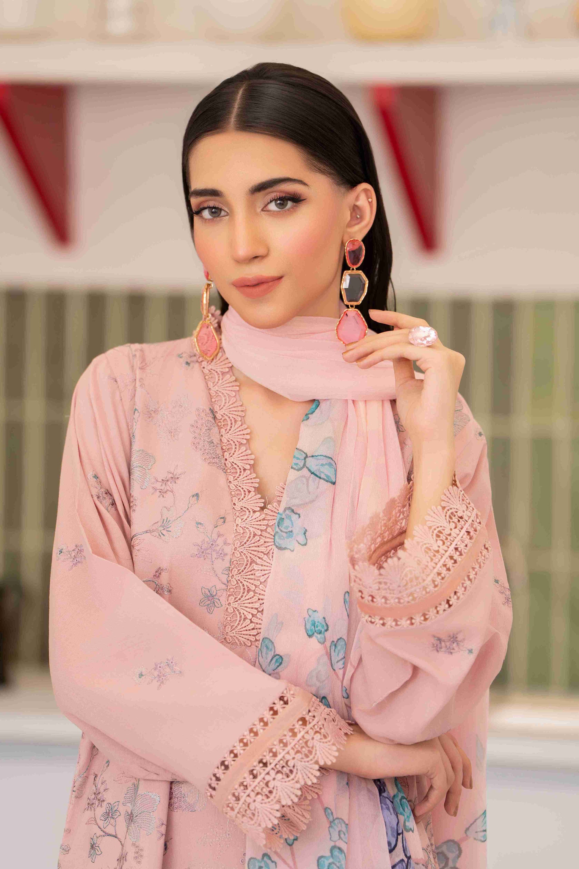 Stylish three-piece outfit featuring embroidered lawn shirt, chiffon dupatta, and cotton trousers