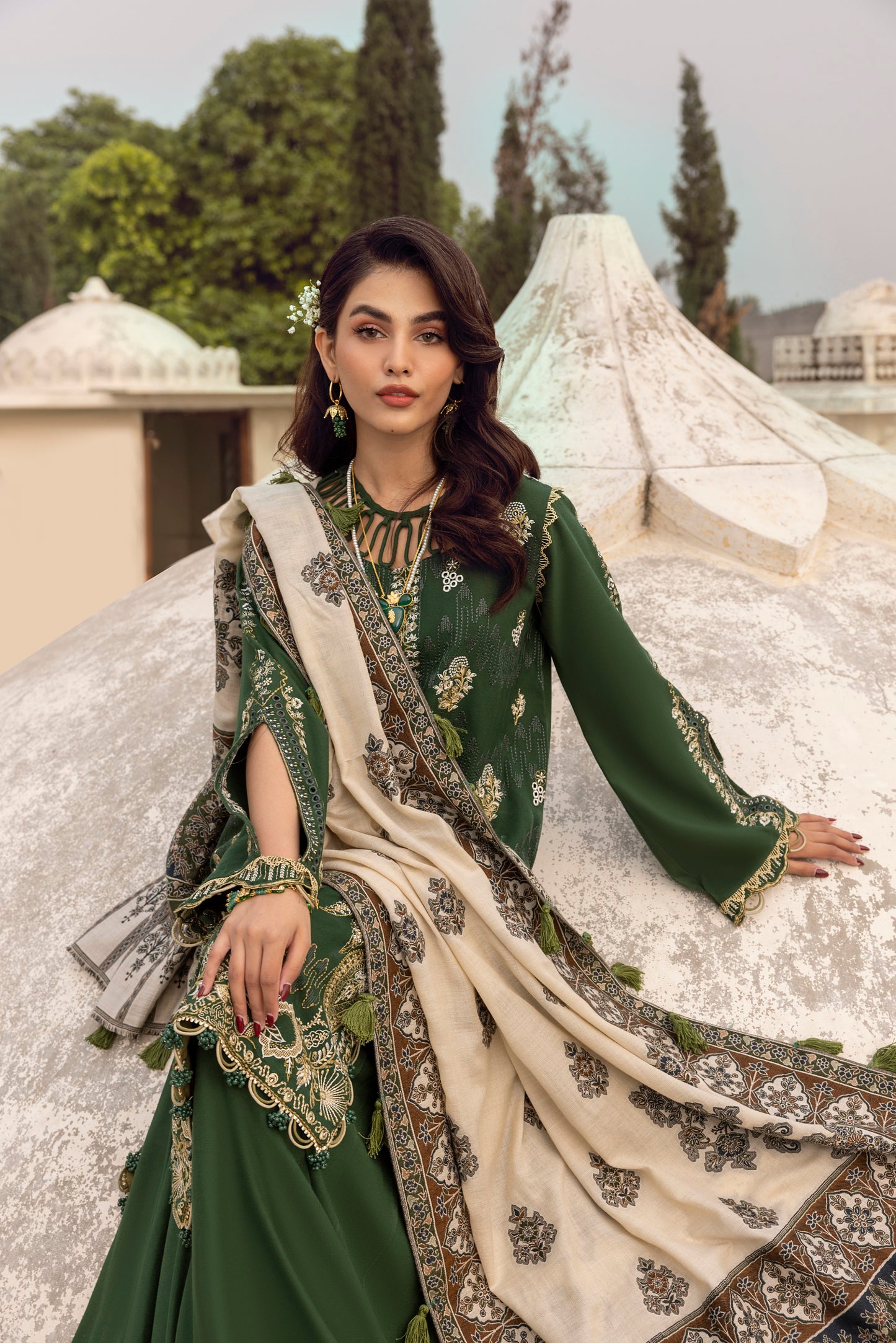 Elegant winter attire made with Marina wool, ornate embroidery, organza enhancement, and a woven Kashmiri shawl.