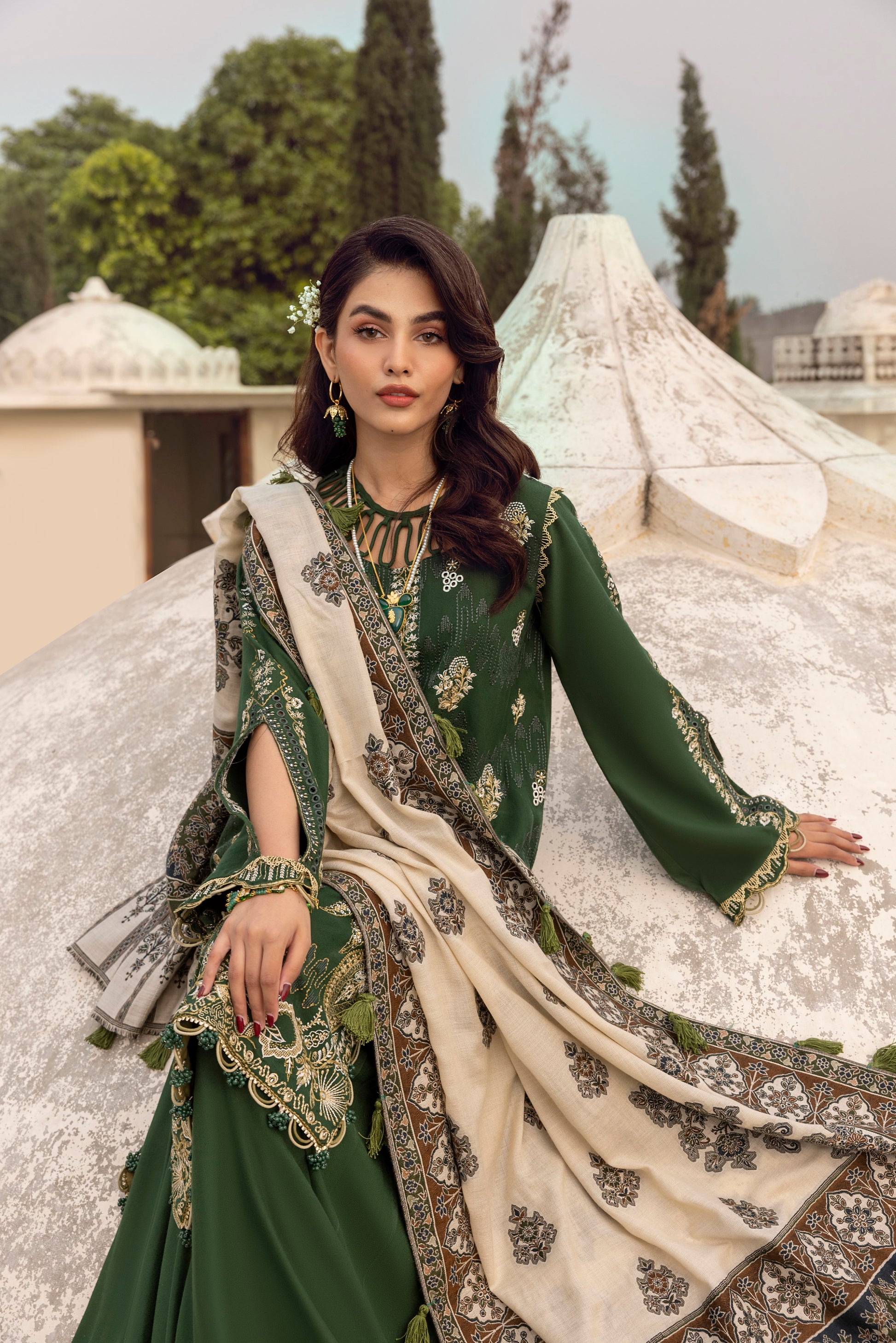 Elegant winter attire made with Marina wool, ornate embroidery, organza enhancement, and a woven Kashmiri shawl.