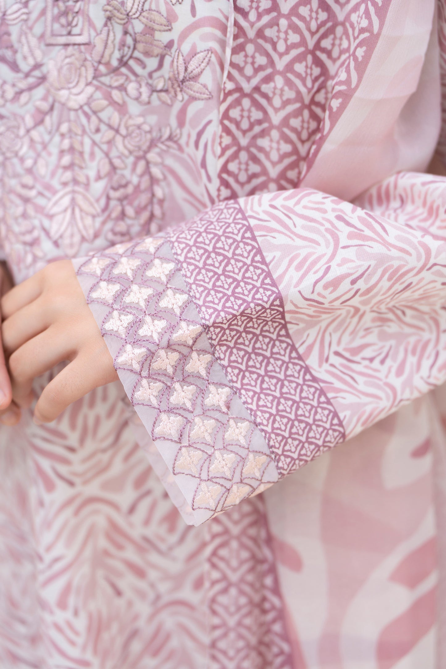 Detailed view of embroidered sleeve cuff on pastel pink 3-piece lawn suit, premium fabric highlighting Pakistani dress design