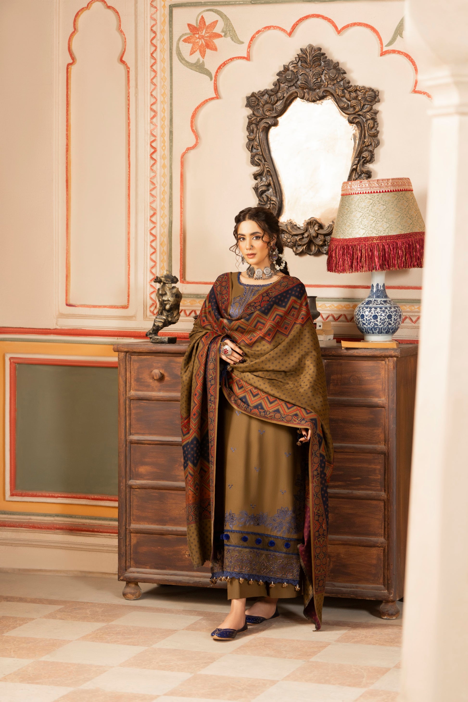Embroidered Dhanak suit accented by a jacquard wool shawl for premium warmth.