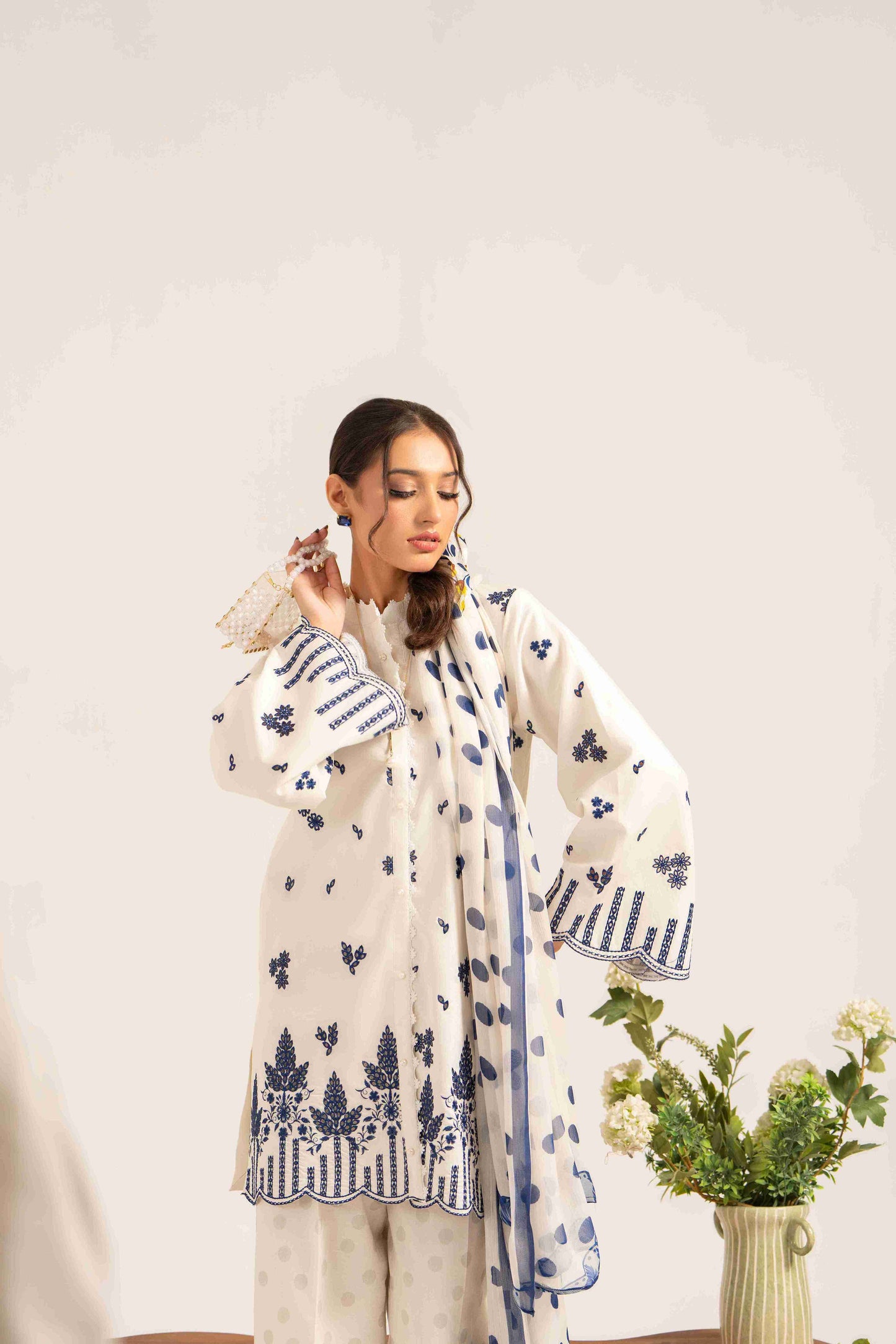Luxury embroidered lawn shirt paired with chiffon dupatta and plain cotton trouser.