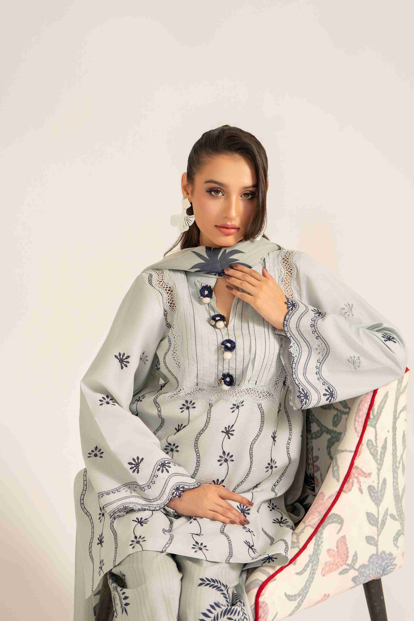 Luxury embroidered lawn shirt styled with chiffon dupatta and plain cotton trouser.