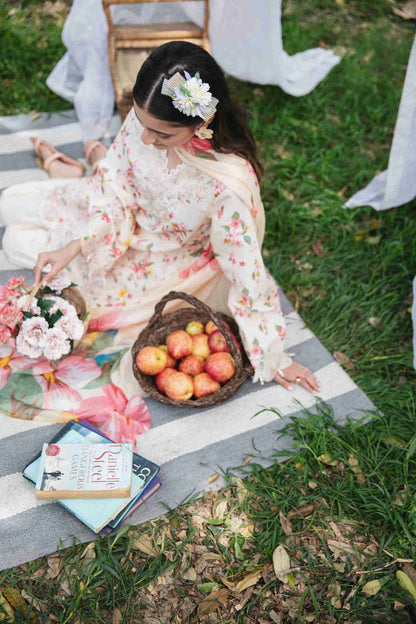 Embroidered lawn suit styled with chiffon dupatta and plain cotton trouser.
