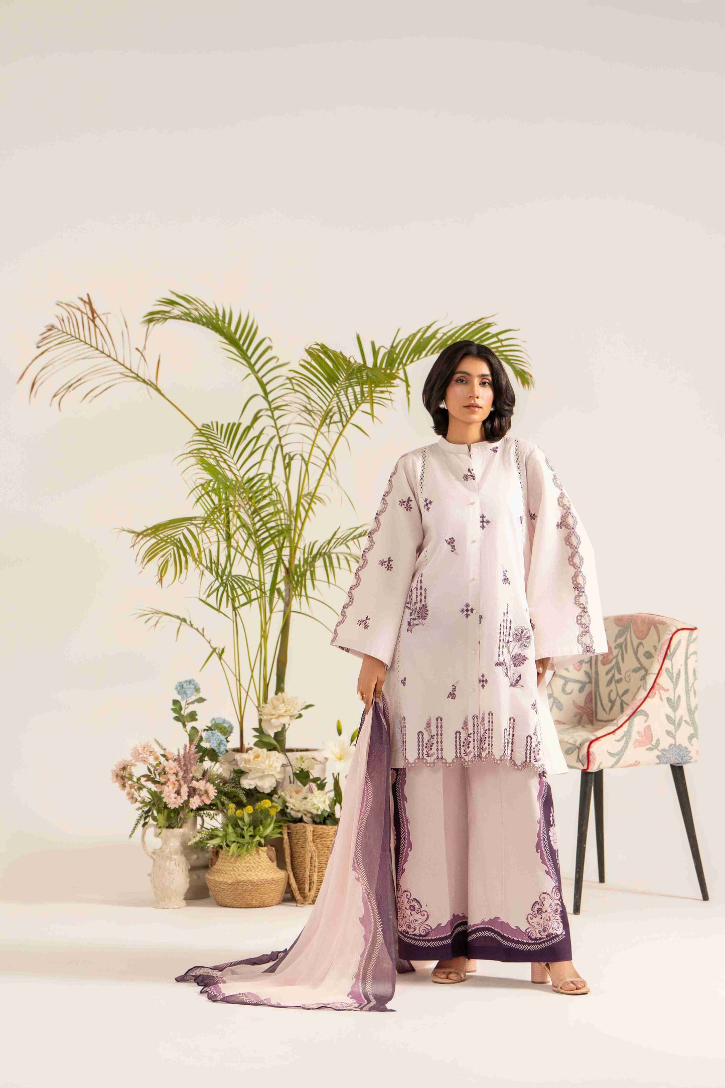 Premium embroidered lawn shirt styled with chiffon dupatta and soft cotton trouser.