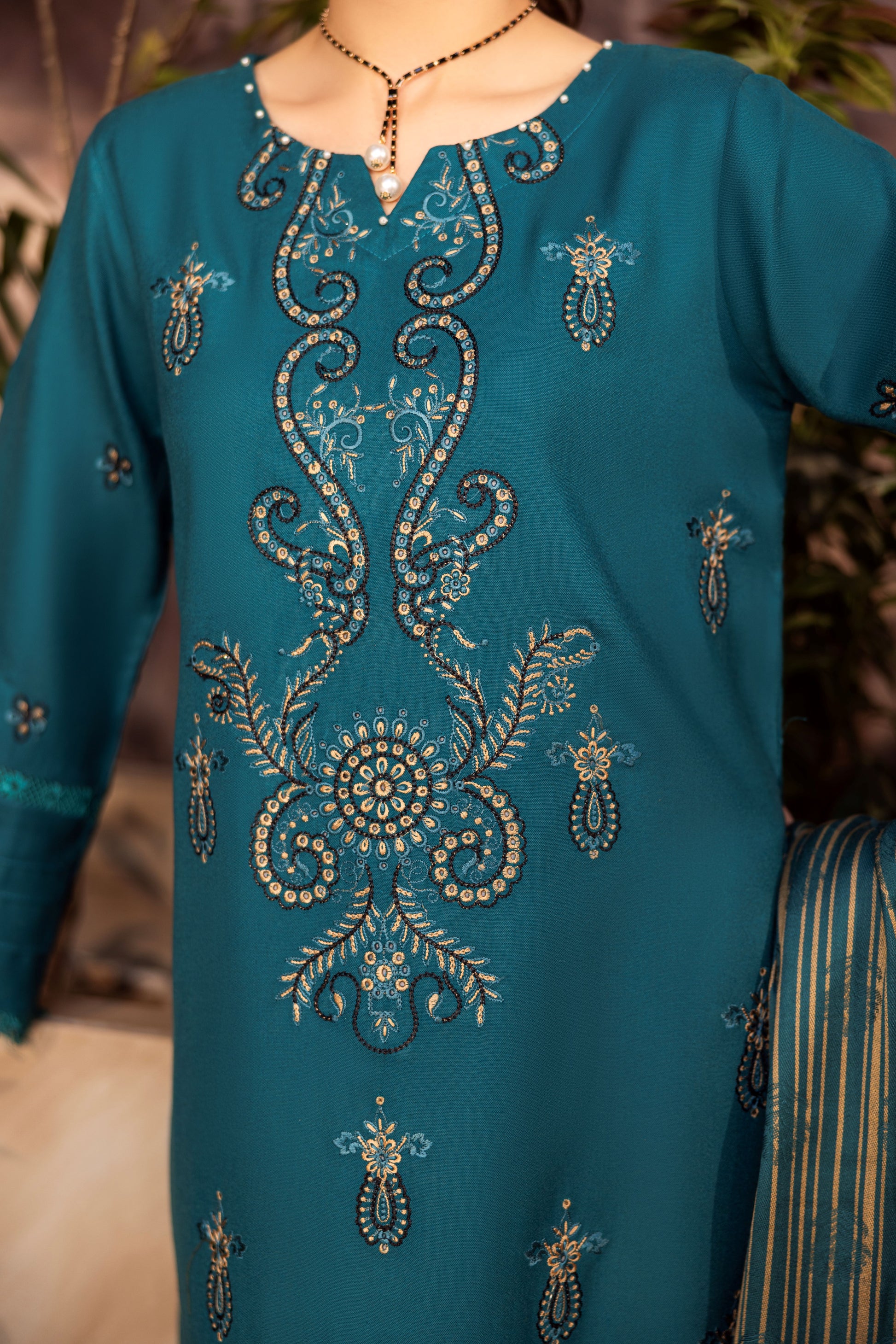 Dark winter embroidered suit styled for formal wedding reception.