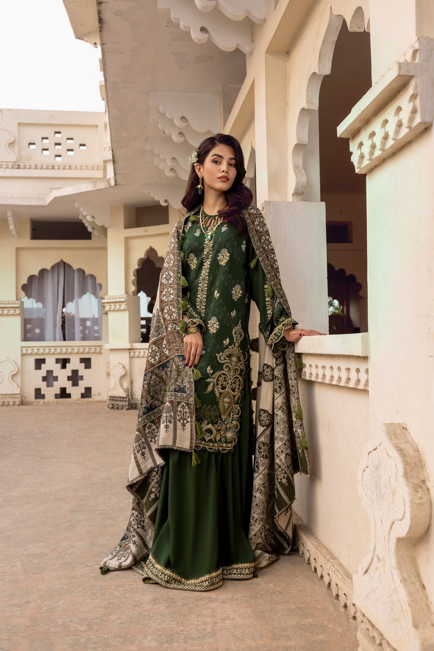 Unstitched winter design built around a handmade Kashmiri shawl, embroidered front panel, and classic trousers with border detailing.
