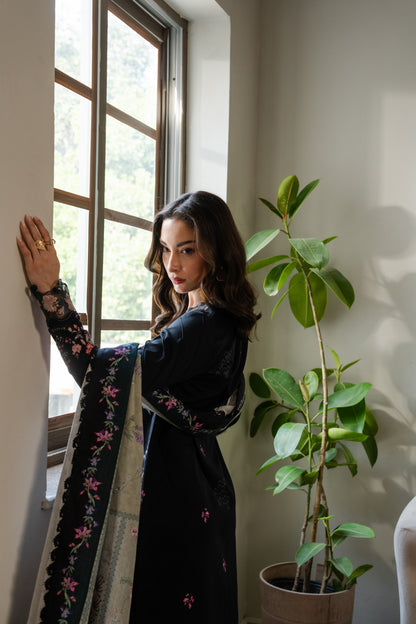 Soft printed khaddar shirt with subtle organza embroidery and comfortable winter trousers.