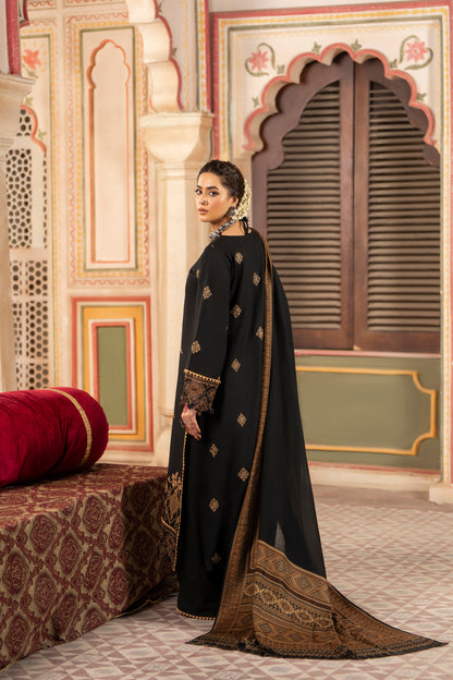 Winter embroidered Dhanak ensemble paired with jacquard wool shawl for an elegant seasonal look.