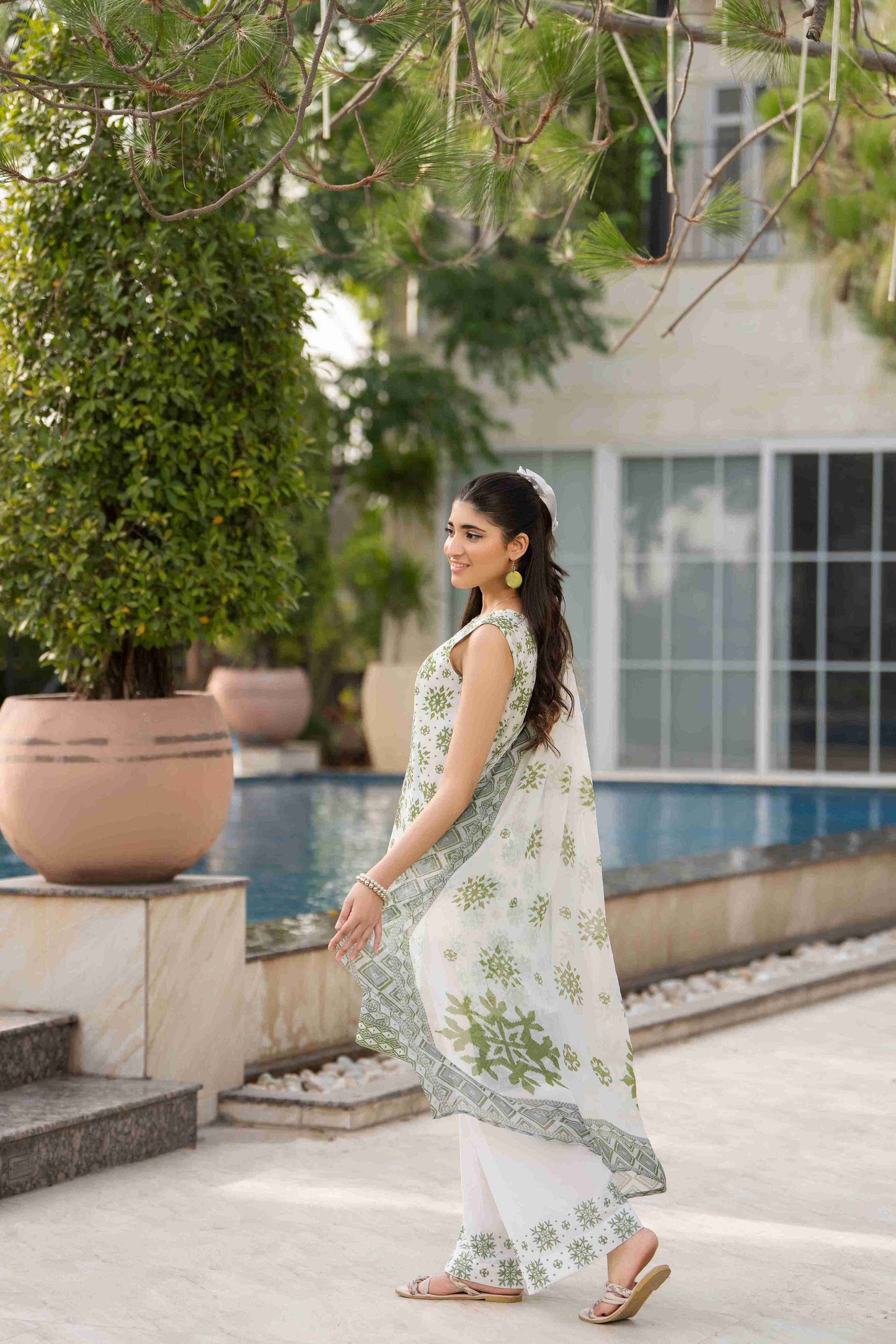 A timeless three piece dress for women, blending embroidered lawn, a soft cotton trouser, and a traditional dupatta style