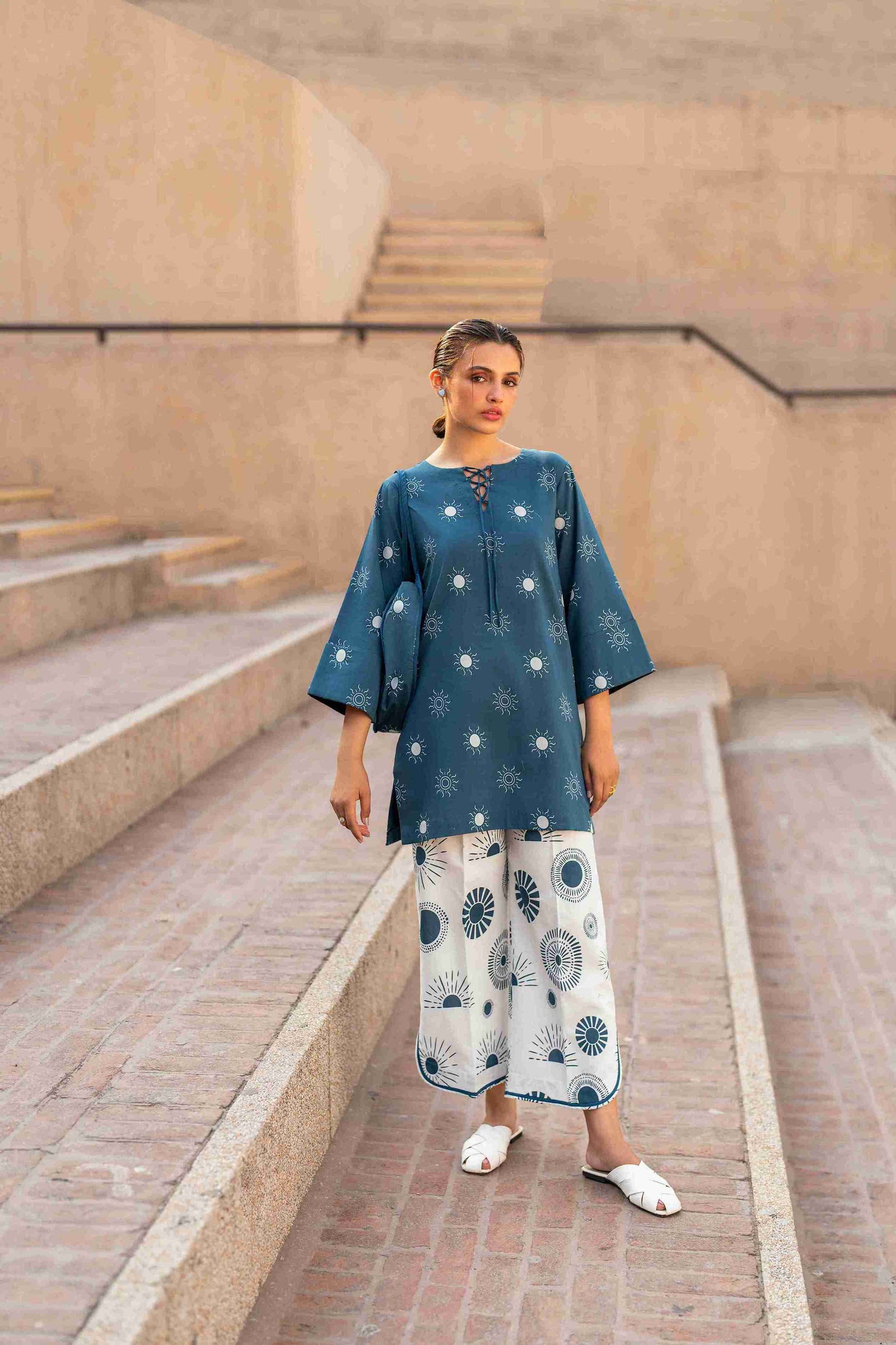 Stitched Jacquard tunic with crisscross neckline, bell sleeves, and cotton bell bottom trousers