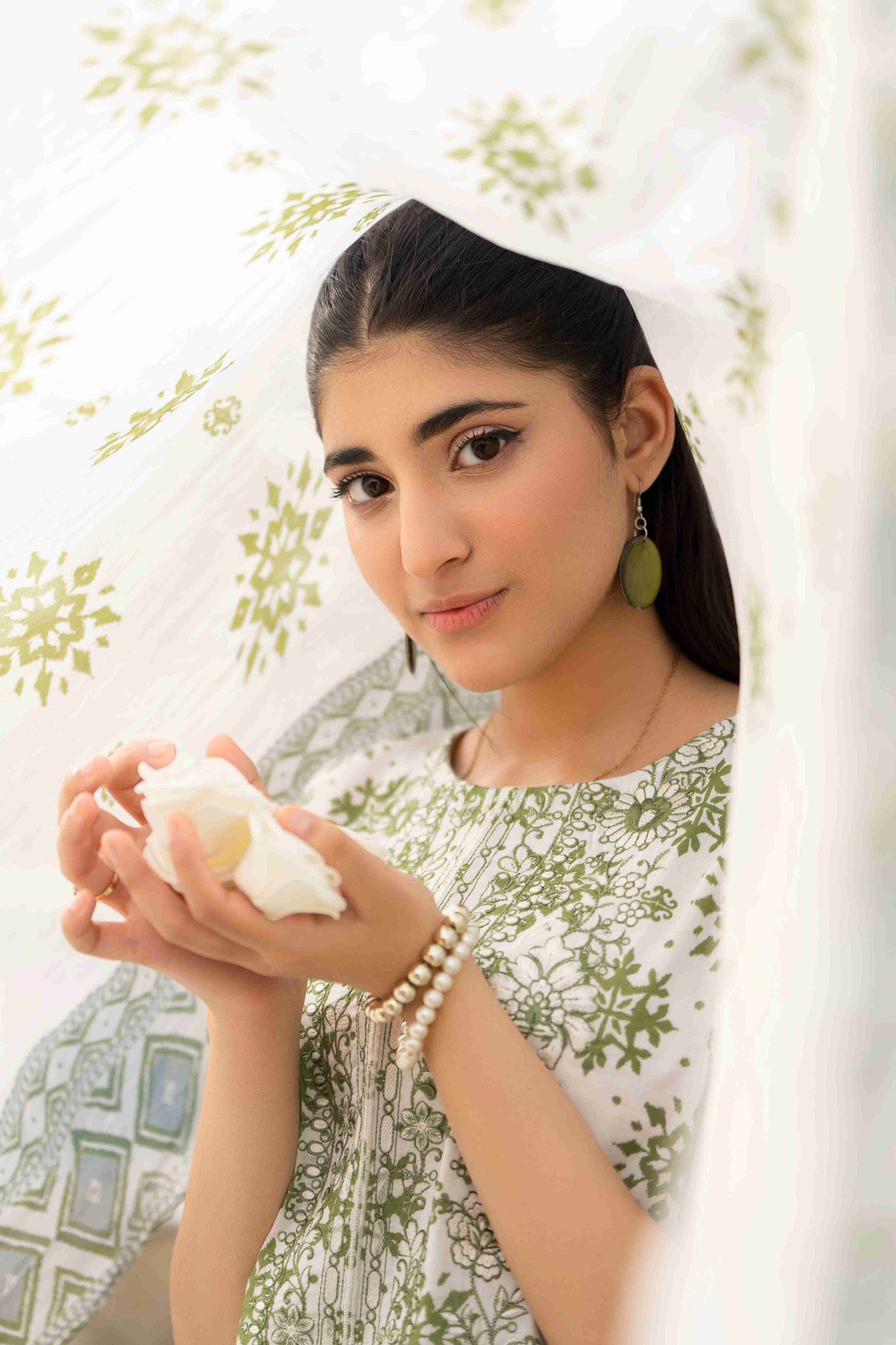 A versatile unstitched lawn dress featuring an embroidered neckline, cotton trouser, and a light dupatta, ideal for every occasion