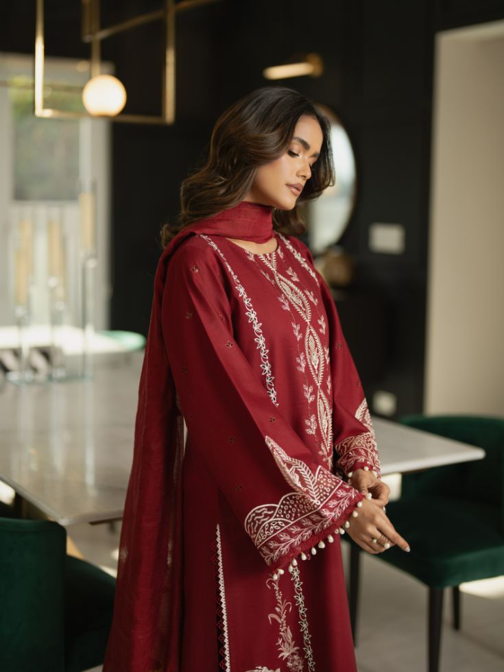 Embroidered wedding dress with motifs, patchwork, and soft cotton dupatta.
