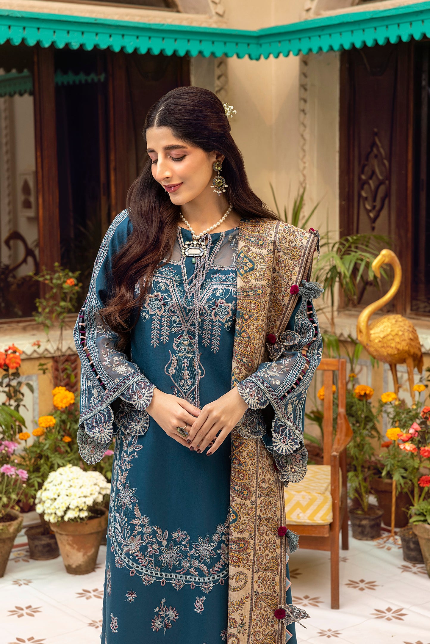 Traditional Pakistani winter ensemble designed with Marina wool fabric, embroidered neckline, organza accents, and a handwoven shawl.