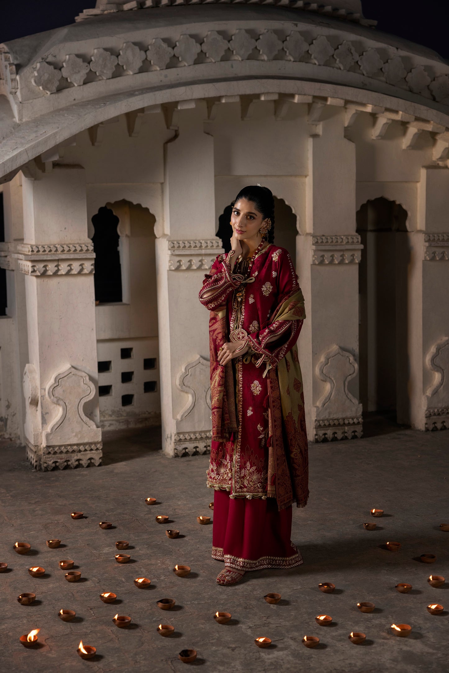 A pure winter ensemble with organza neck work and a woven shawl.