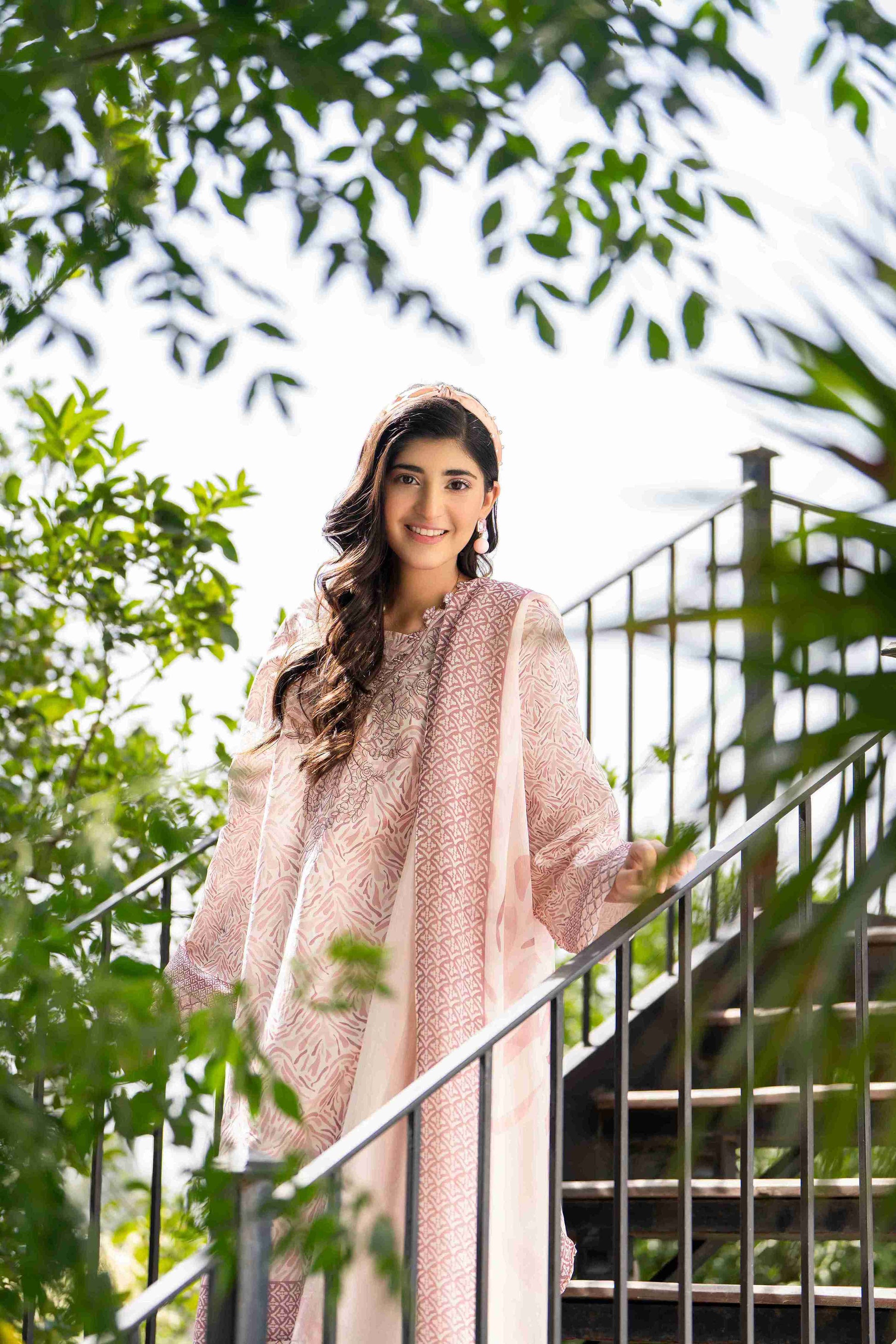 Woman in hot pink embroidered kurta with straight trousers and lightweight chiffon dupatta, radiating bold ethnic summer charm